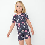 Girl wearing the Moonlit Galaxy bamboo short pajama set